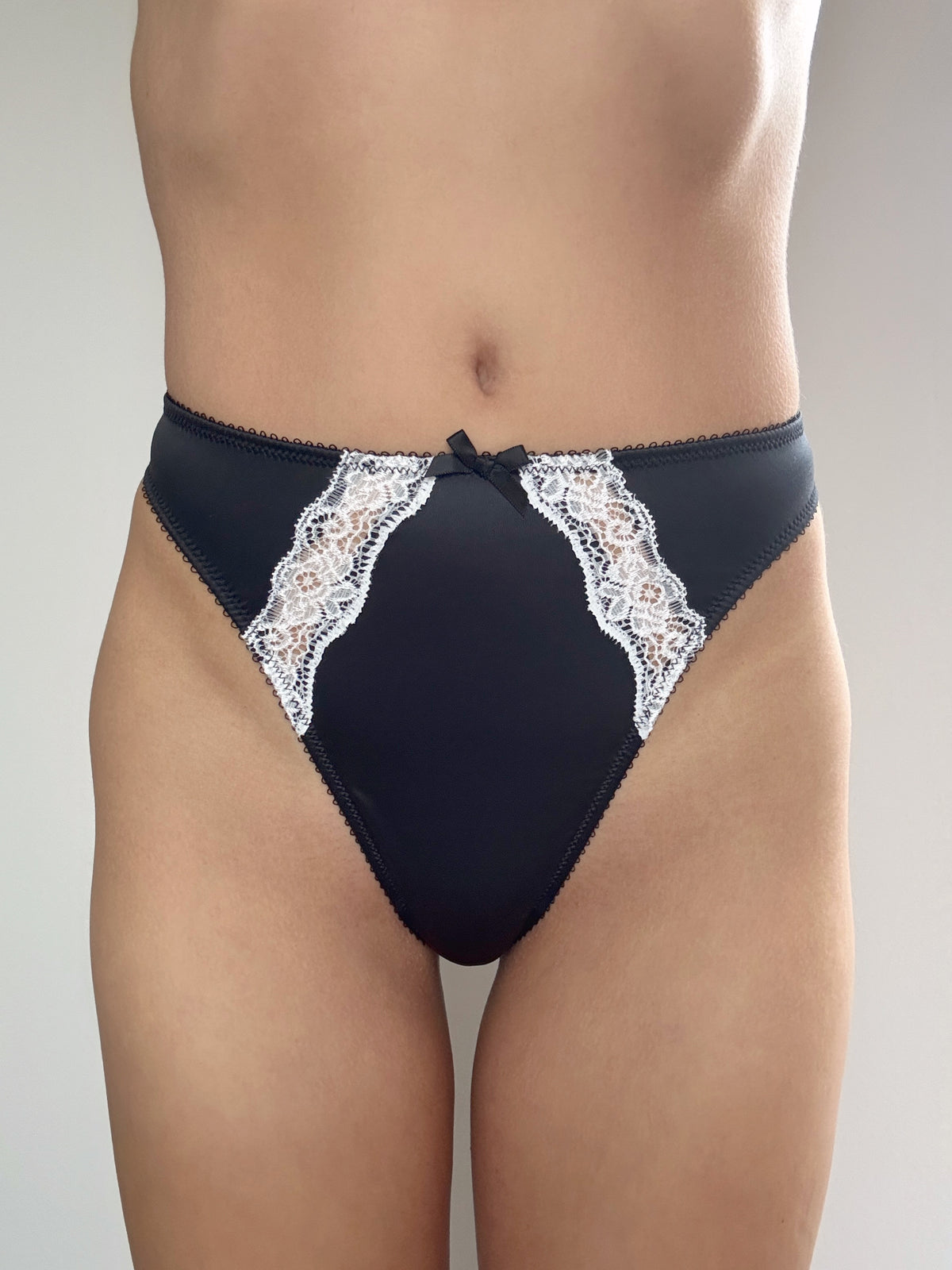 Midnight black thong panties with white lace V-front and center bow