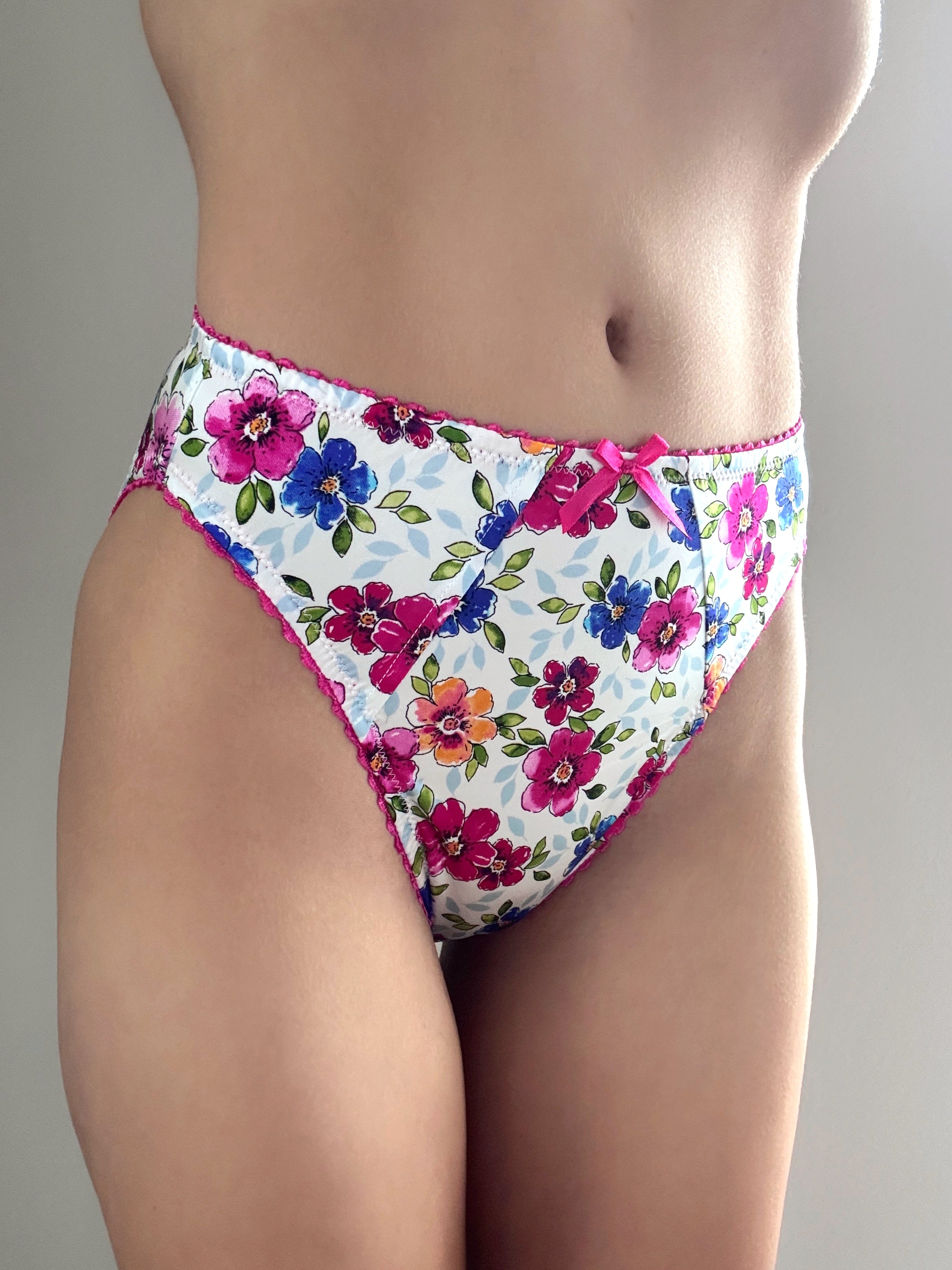 Floral bikini-style panties with multicolor bouquet print and pink-trimmed leg openings
