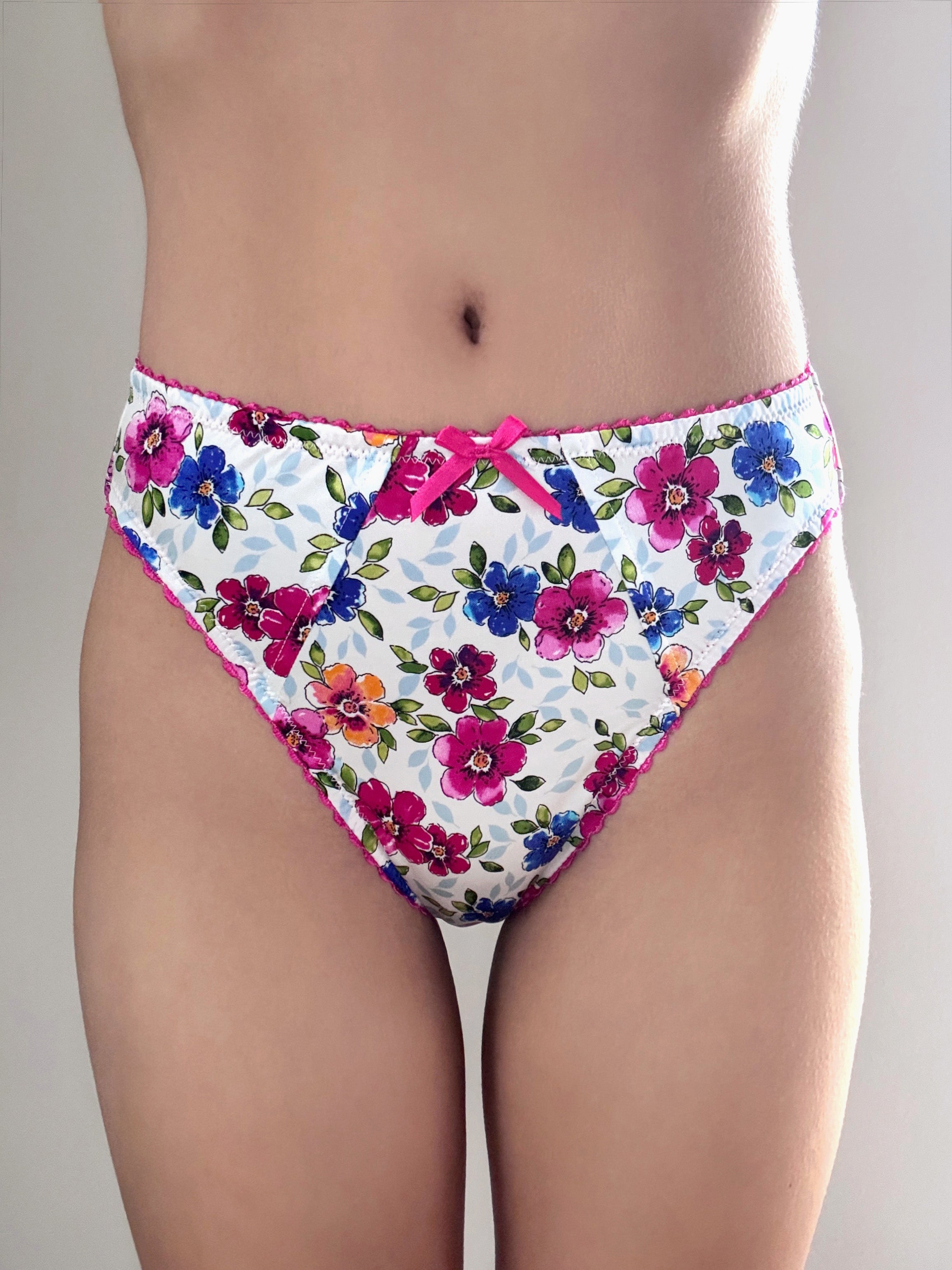 Floral panties with pink bow at center front, multicolor bouquet print and pink trim