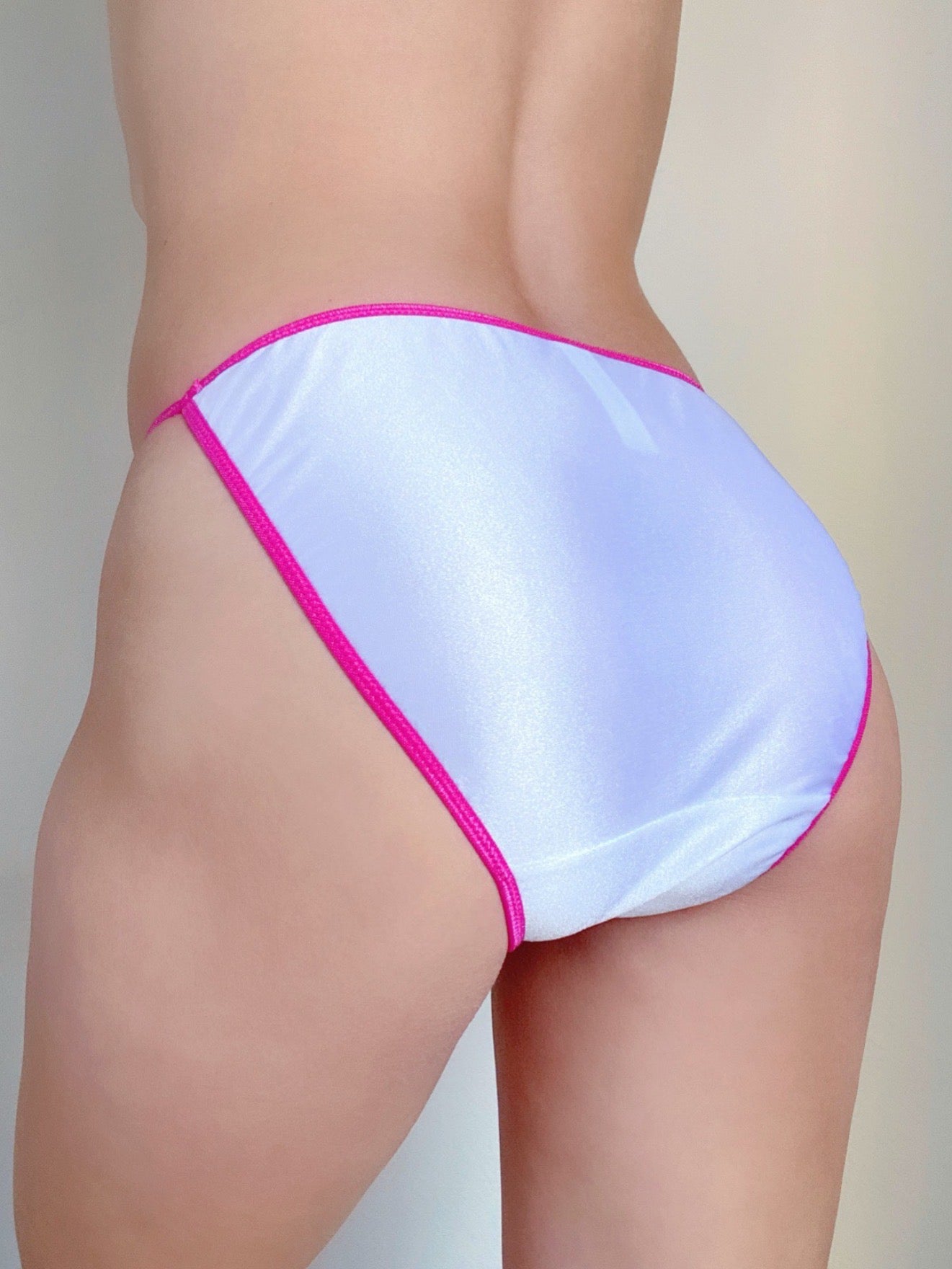 String bikini panties, light blue with hot pink trim, high-cut back view