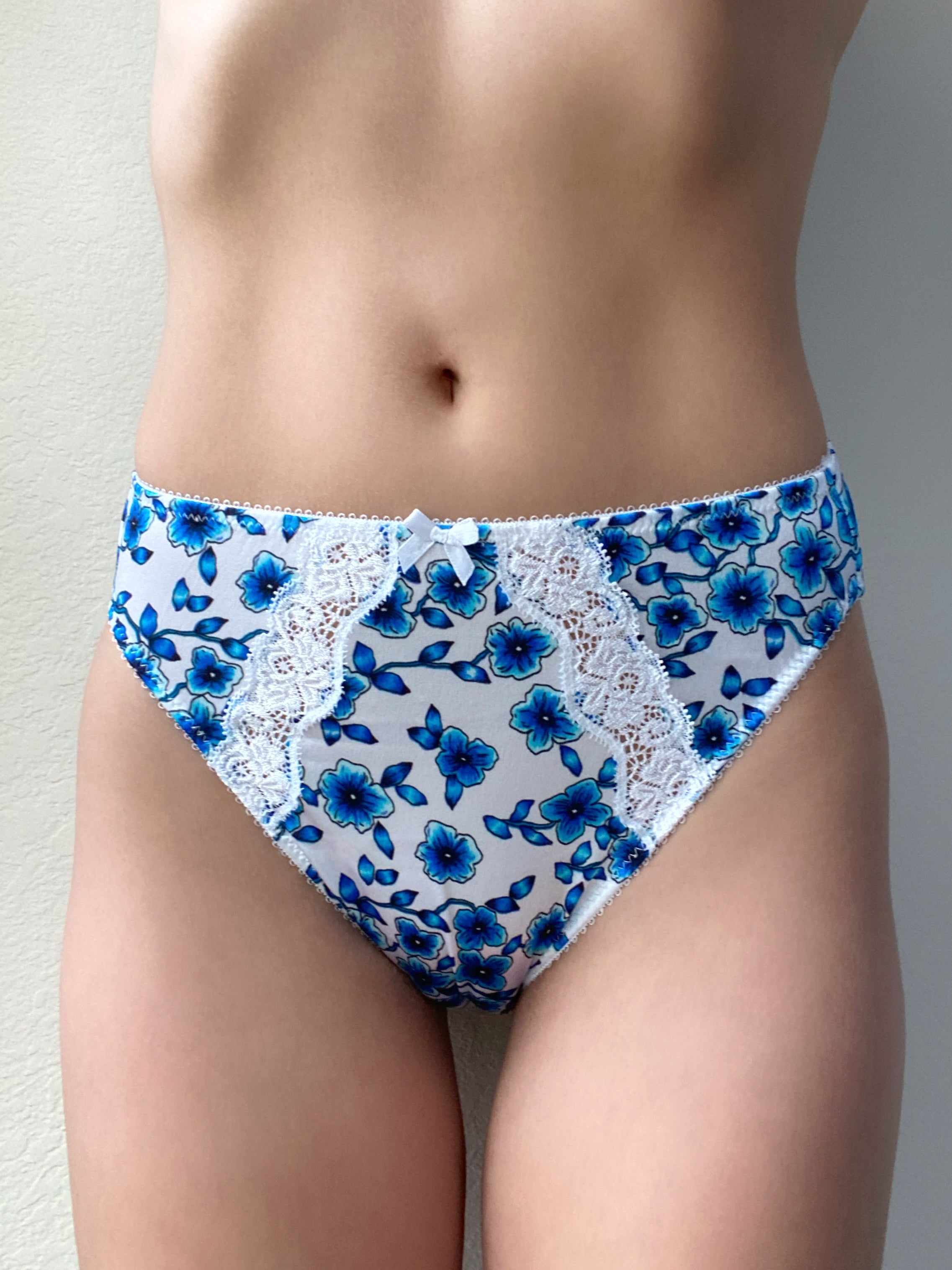 Blue floral bikini panty with white lace applique and bow at center