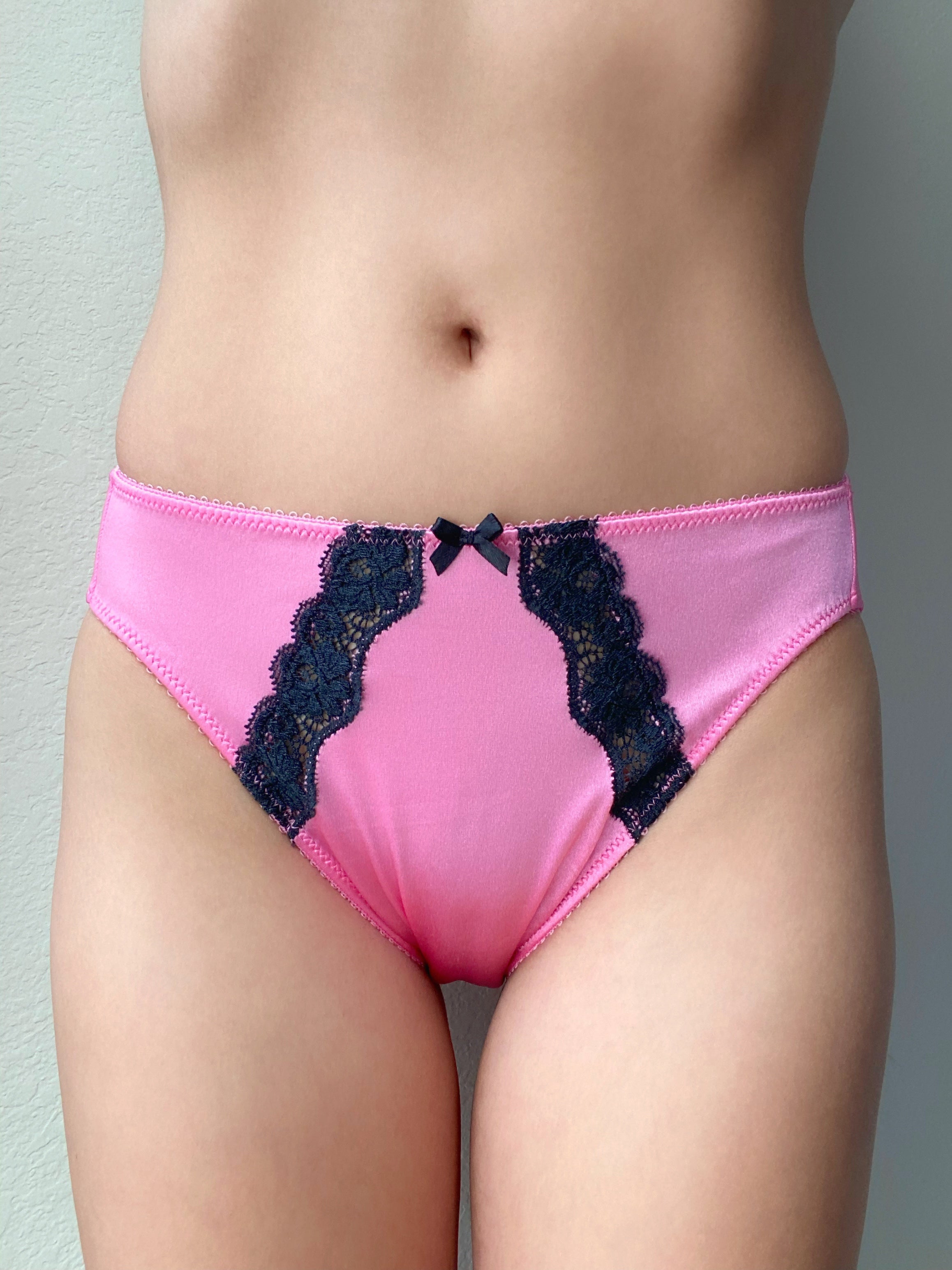 Pink satin bikini panty with black lace inserts and bow at the center front