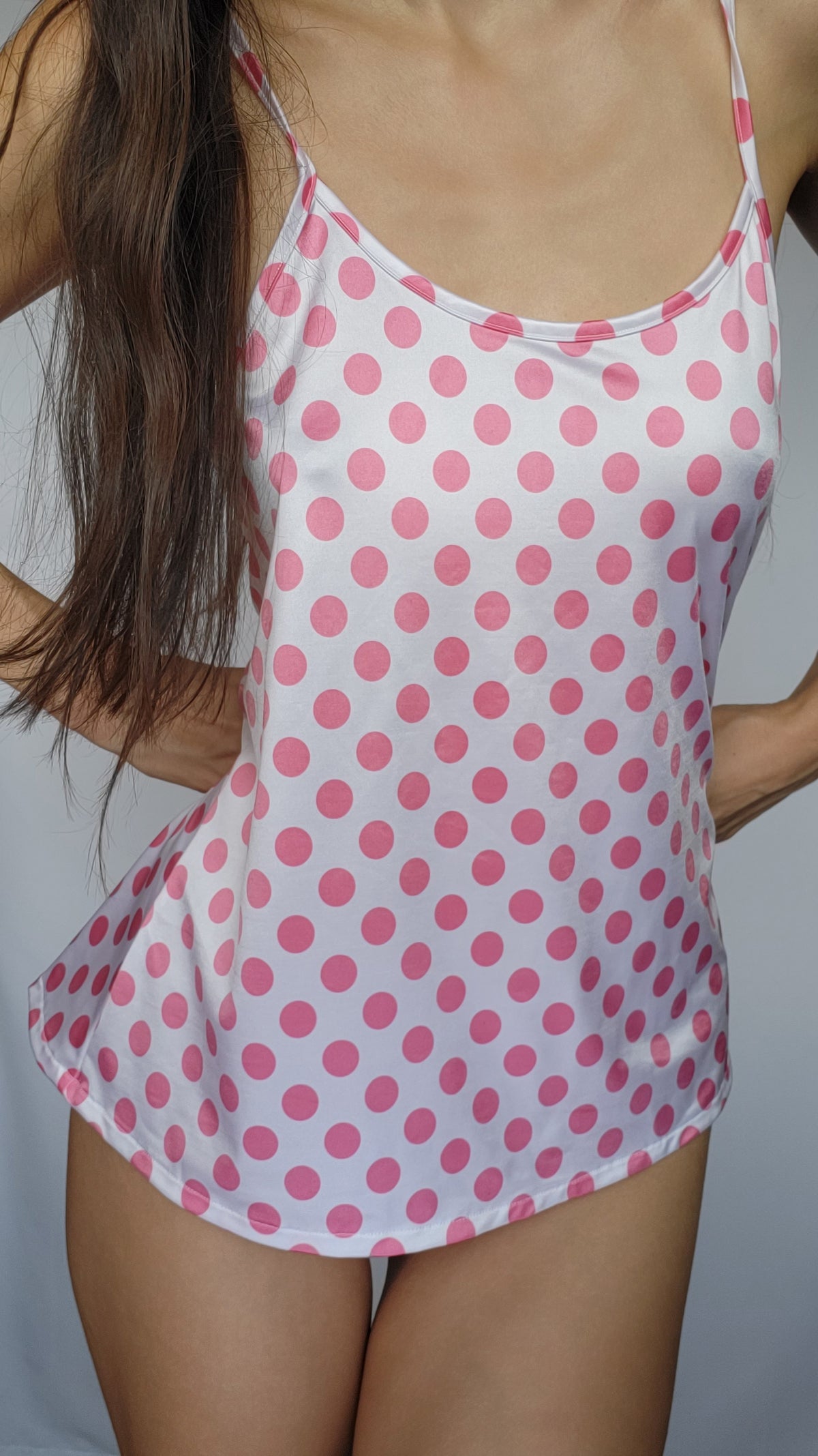 Pink polka-dot camisole with thin straps and scoop neck, white base