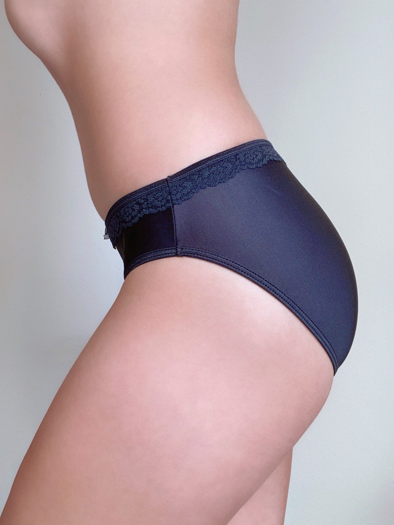 Side view of lace-trim brief panties with smooth front, dark blue