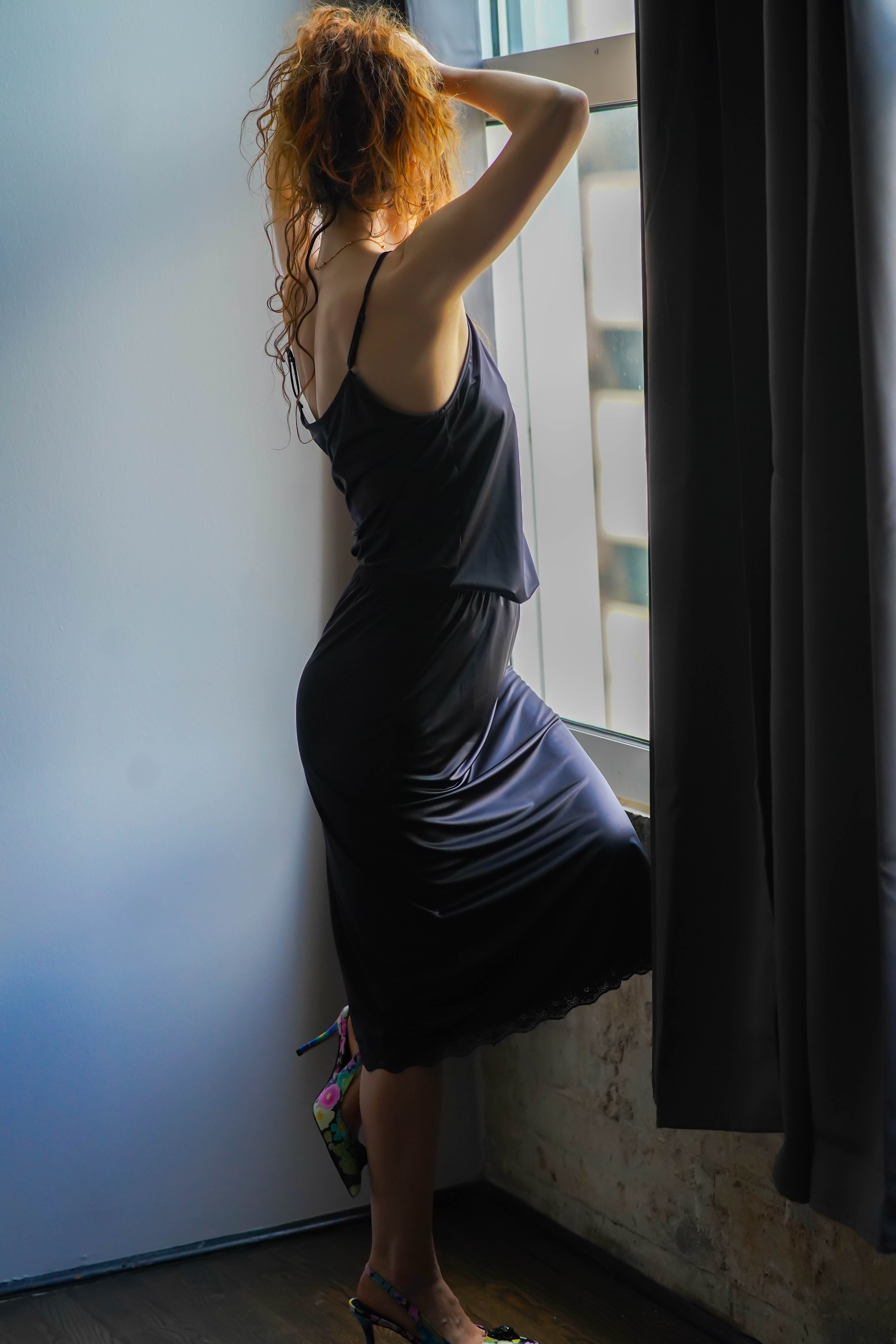 Katie half slip in midnight black satin, back view with lace-trimmed hem edge.