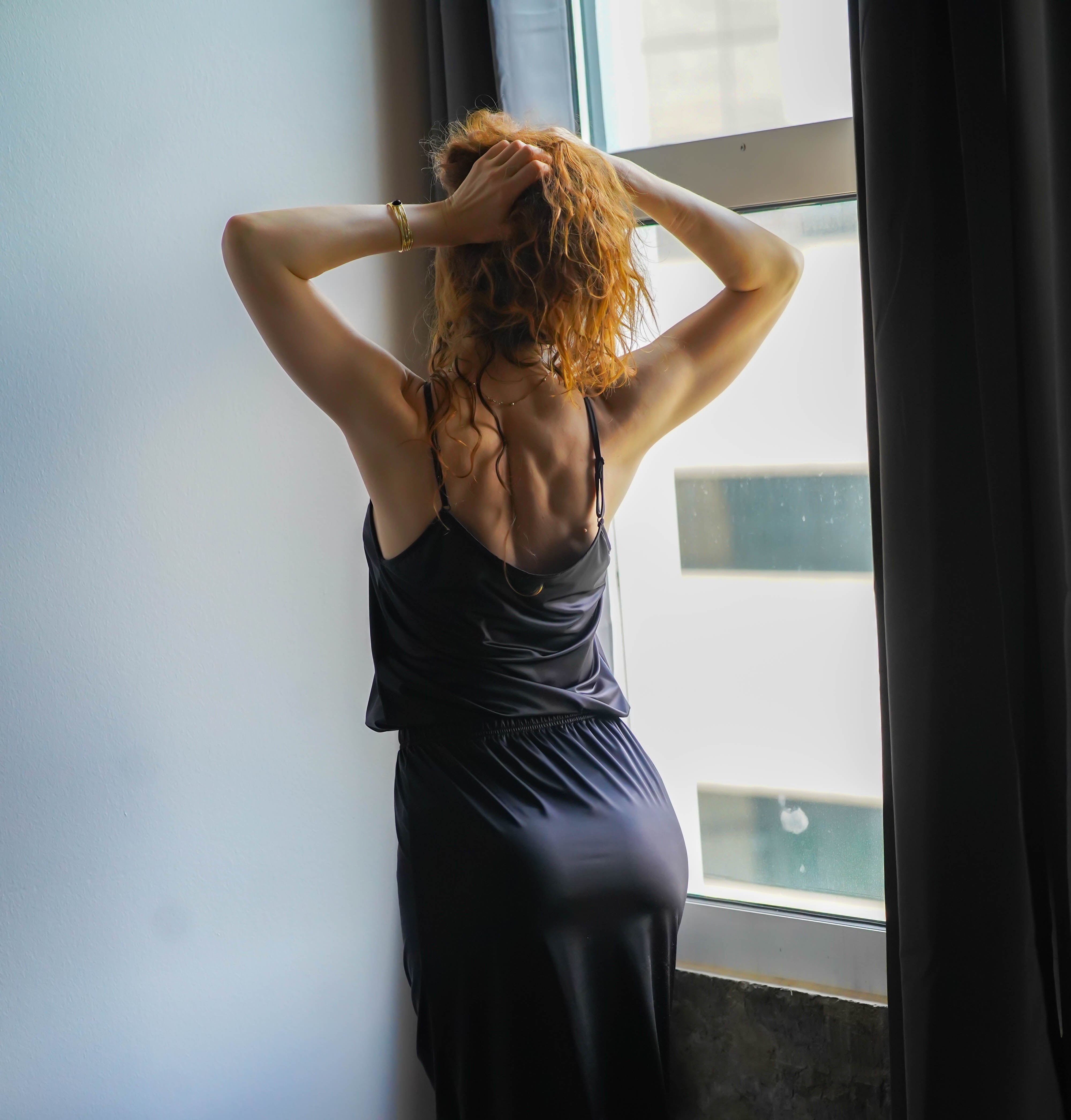 Katie half slip in midnight black satin with lace hem and elastic waistband, back view.