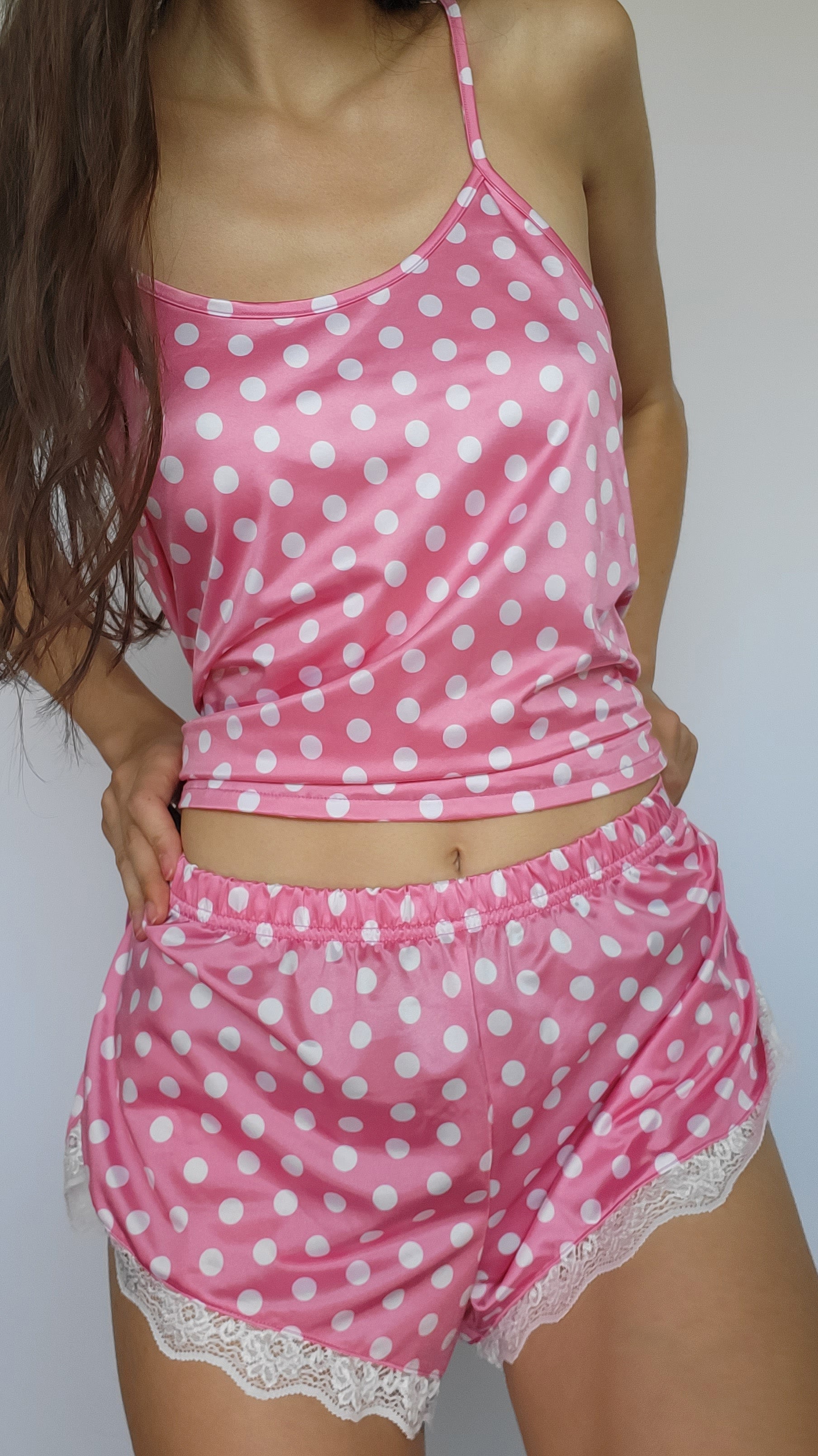 Pink polka-dot shortie pajama set with spaghetti straps and lace-trimmed shorts