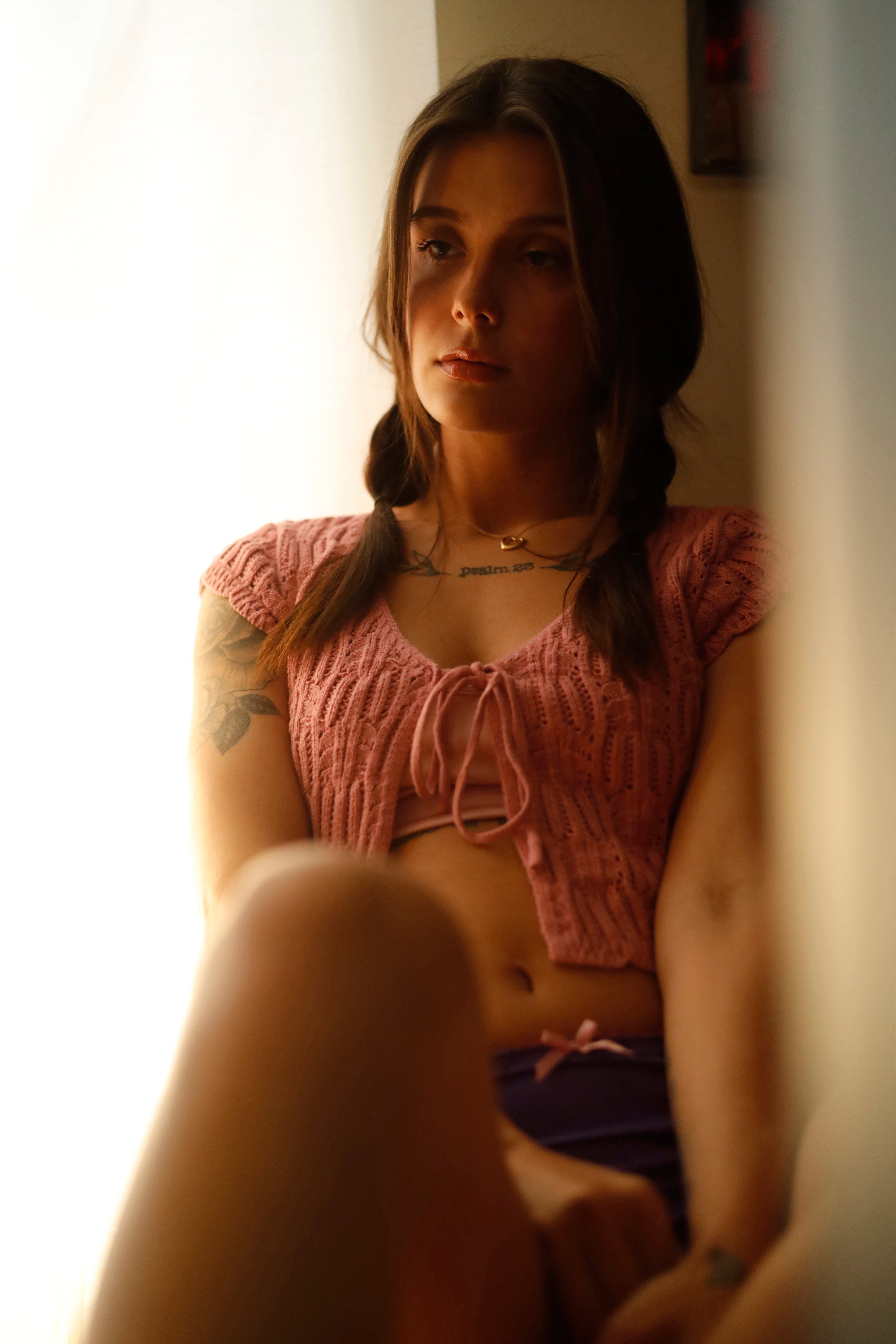 Violet panties with pink trim worn under a pink dress