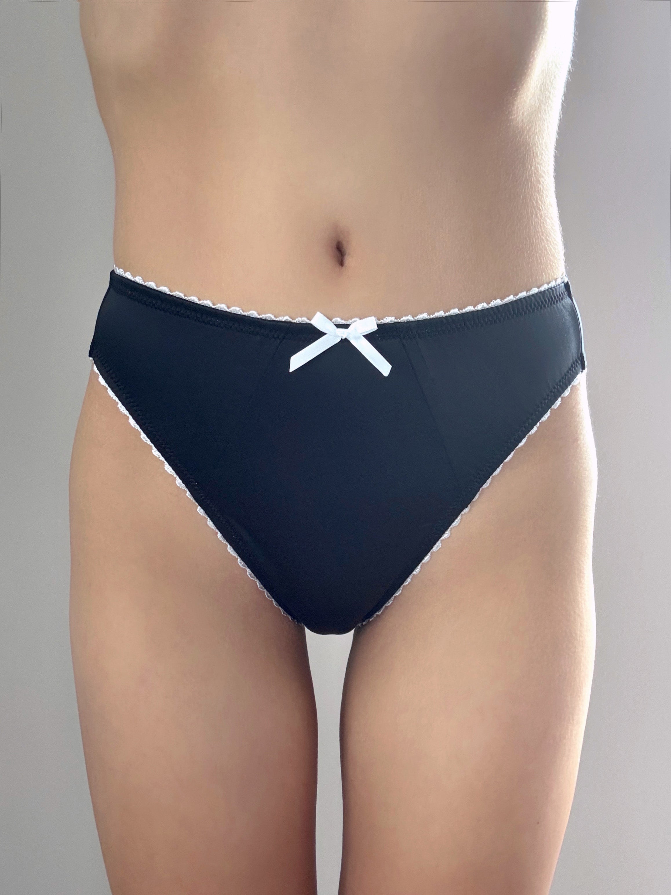 Midnight black panties with white trim and center bow, front view