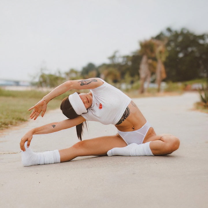 White hipster panty, seated pose with lace-trim waistband, front view