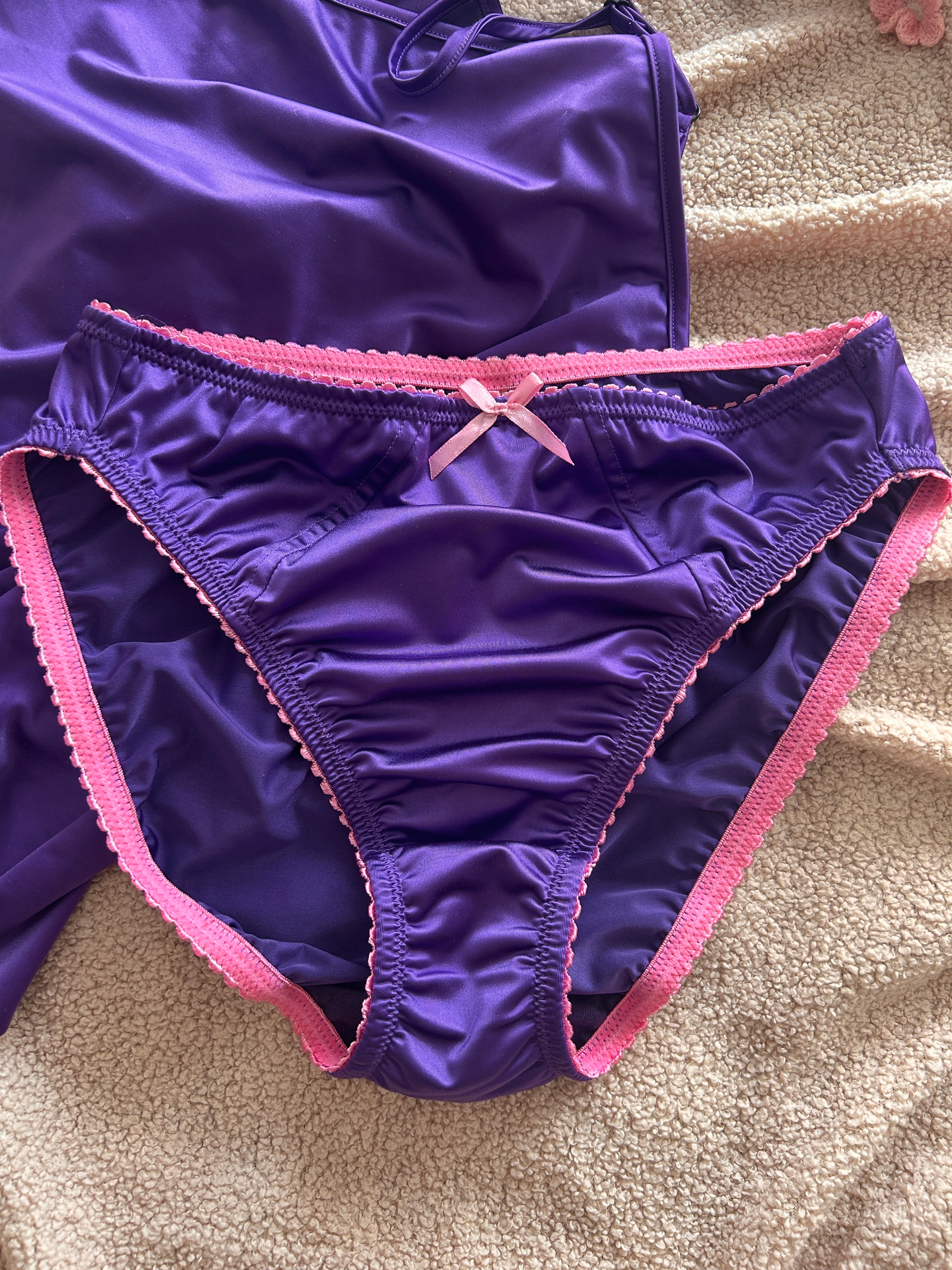 Violet satin panties with pink trim and center bow, back view