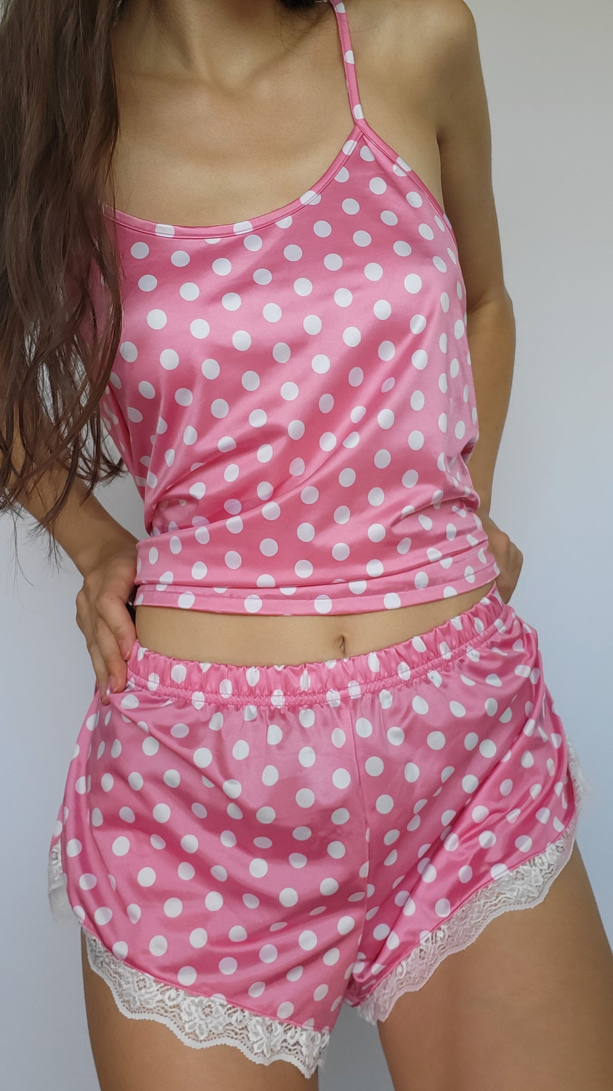 Pink polka-dot shortie pajama set with spaghetti straps and lace-trimmed shorts